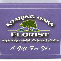 Purple florist gift box with a Roaring Oaks Florist logo and text