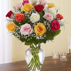 Mixed roses in a clear glass vase with baby's breath