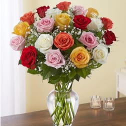 Mixed roses in a clear glass vase on a table
