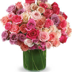 Large bouquet of pink and lavender roses in a glass vase