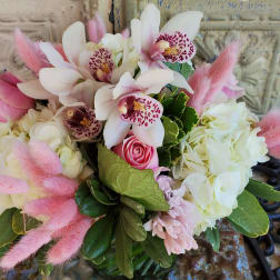 Pink and white bouquet with orchids, roses, hydrangeas, and fluffy pink accents