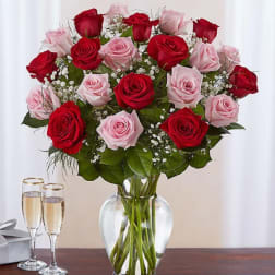 Bouquet of red and pink roses in a clear glass vase