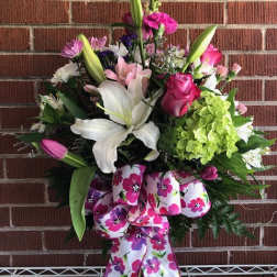 Mixed bouquet with lilies, roses, and hydrangea in a glass vase