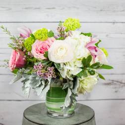 Pink and white mixed flower arrangement in a glass vase