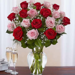 Bouquet of red and pink roses in a clear glass vase