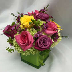 Colorful rose bouquet in a green square vase