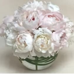 Bouquet of pale pink and white peonies in a round vase