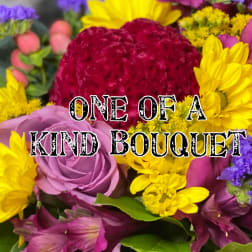 Colorful bouquet with roses, daisies, and purple filler flowers