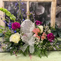 Floral sympathy arrangement with roses, carnations, and a memorial stone
