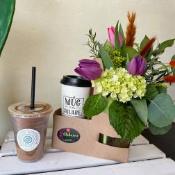 Bouquet with purple tulips and green hydrangea in a kraft box
