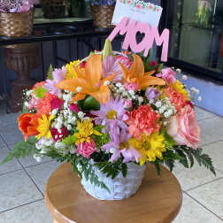 Colorful mixed flower basket with a pink MOM sign