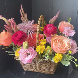 Basket of pink and peach flowers with yellow daisies
