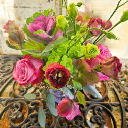 Bouquet of pink roses and green blooms in a vase