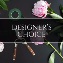 Pink peony blooms with floral tape and pruning shears on a dark background