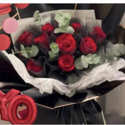 Bouquet of red roses wrapped in black and white paper
