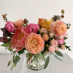 Mixed pink and peach bouquet in a clear glass vase