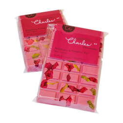 Two pink raspberry and pistachio chocolate bars in clear wrappers with bright pink labels.