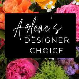Designer choice floral arrangement with pink, orange, and yellow blooms