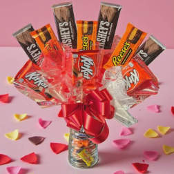 Candy bouquet in a glass jar with a red bow