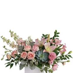 Pink lilies and roses in a white rectangular vase