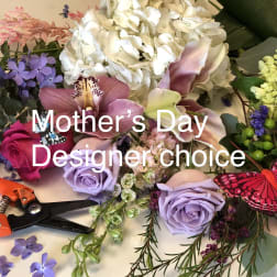 Mixed floral arrangement with roses, orchids, hydrangea, and butterflies