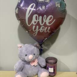 Heart-shaped "love you" balloon with a plush teddy bear and candle