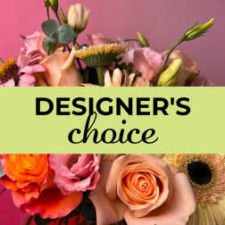 Assorted peach and pink roses and other blooms with Designer's Choice text across the center