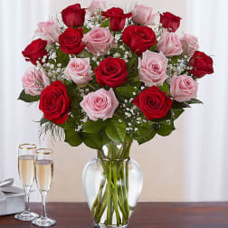 Bouquet of red and pink roses in a clear glass vase