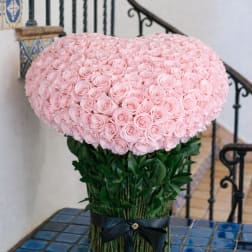 Large pink rose arrangement with a black ribbon tie
