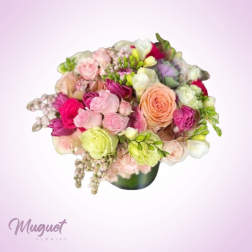 Mixed pink, peach, and white bouquet in a dark vase