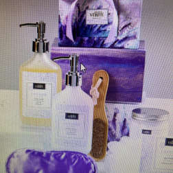 Purple bath gift set with soap dispensers, brush, and wrapped package