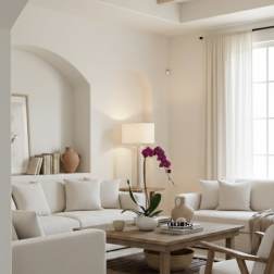 Potted purple orchid on a coffee table in a bright living room