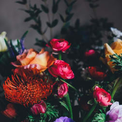 Mixed bouquet with bright pink, orange, purple, and white flowers