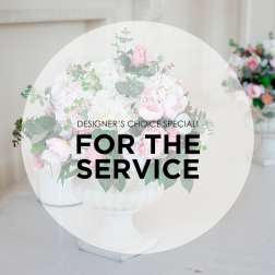 Pink and white floral arrangement in a white pedestal vase