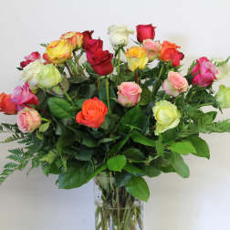 Bouquet of multicolored roses in a clear glass vase