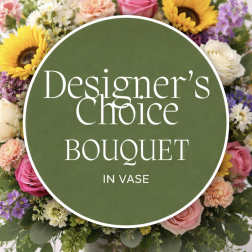 Mixed bouquet of sunflowers, roses, and other blooms in a clear vase with a text overlay.