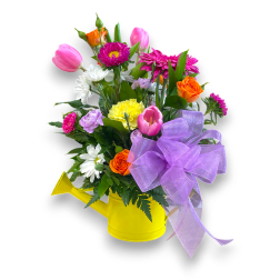 Mixed bouquet in a yellow watering can with a purple bow