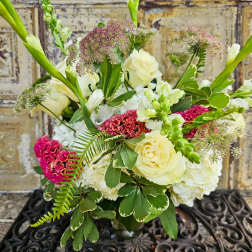 Bouquet of cream roses and white blooms with pink accents