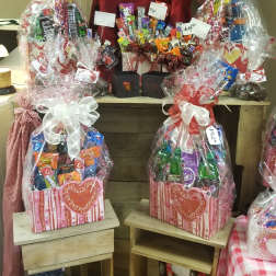 Gift baskets filled with assorted candy and wrapped in clear cellophane