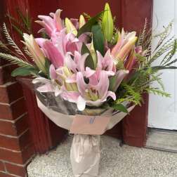 Bouquet of pink lilies wrapped in paper