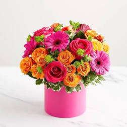 Bouquet of pink, orange, and yellow roses with gerbera daisies in a pink vase