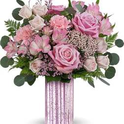 Pink roses and alstroemeria in a pink glass vase