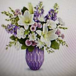 Purple and white floral arrangement in a purple vase