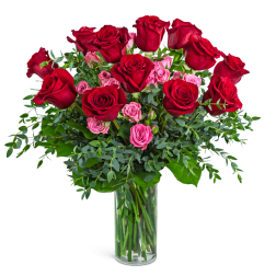Red and pink roses in a clear glass vase