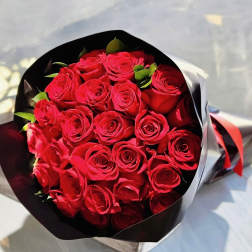 Bouquet of red roses wrapped in black and white paper