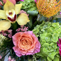 Mixed bouquet with a pink rose, yellow orchid, and bright gerbera daisies