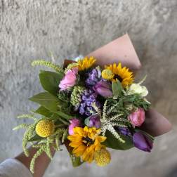 Hand-tied bouquet with sunflowers, purple and pink blooms