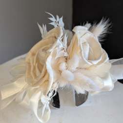 All white dried cuff corsage with silver band.