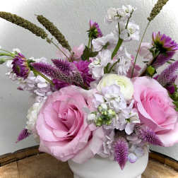 Pink and white floral arrangement in a white vase