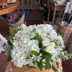 White hydrangea and rose bouquet with green foliage